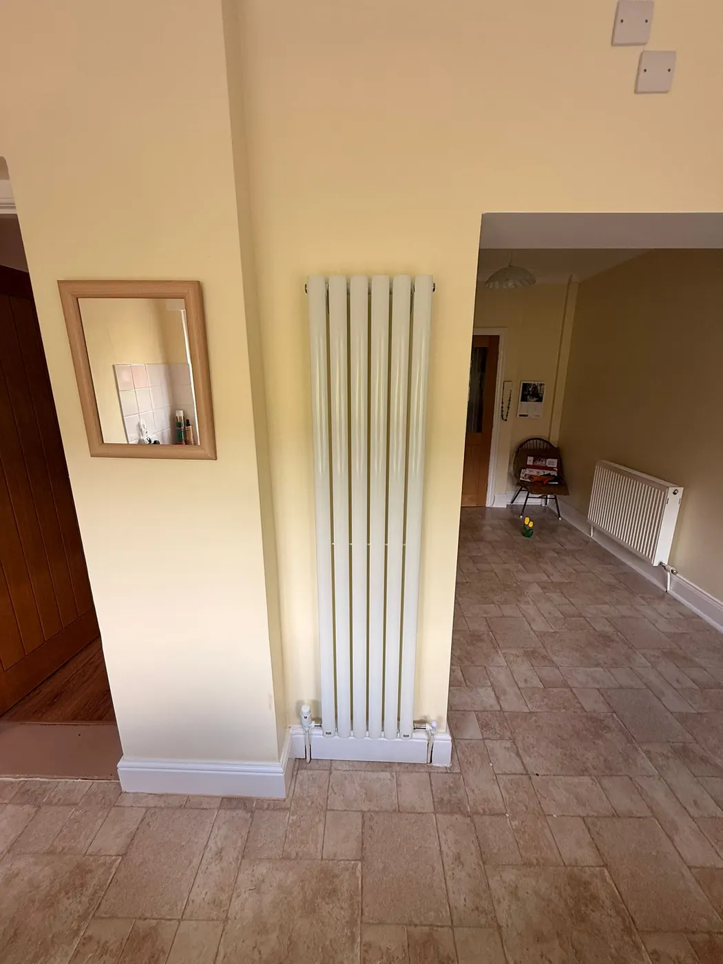 Vertical radiator installed in a hallway